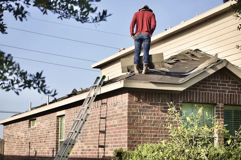 Professional roofer working on a residential roof in Pike Creek